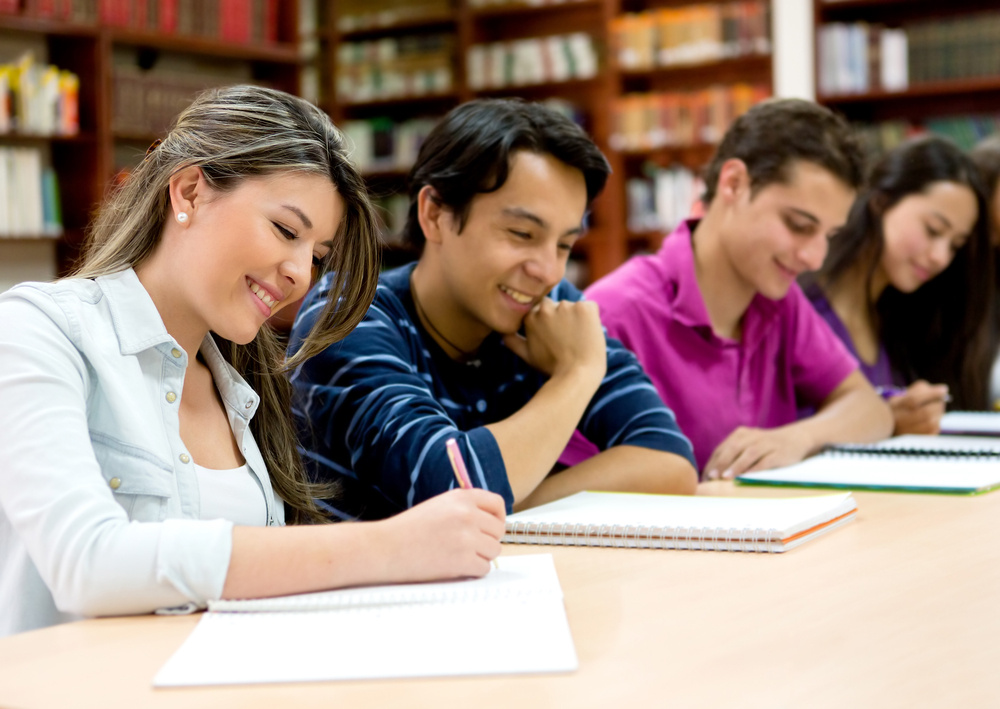 Group of college students studying at the library