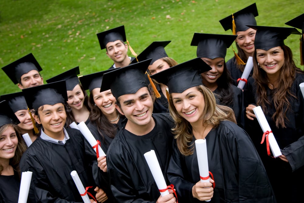 group of graduation students in the park looking happy group of graduation students in the park looking happy
